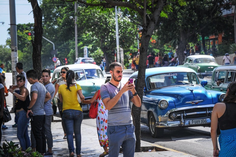 A man takes a picture with his mobile phone in Havana.